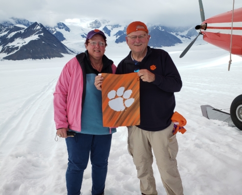Alaska: Mike Ausherman \u201978 and his wife, Chris, took a photo with their Tiger Rag after landing on a glacier in Denali National Park.